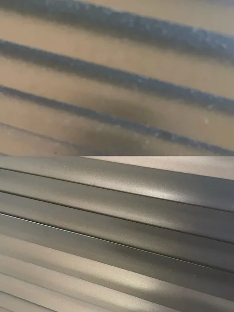 Blind slats with visible surface build-up above and the cleaned slats below