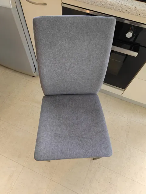 Upholstered dining chair photographed in a kitchen